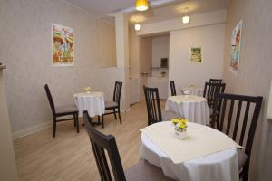 a restaurant with two tables and chairs with flowers on them at Bed & Breakfast Vila Baguc in Split