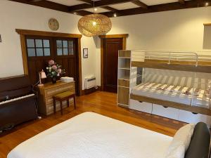 a room with two bunk beds and a desk at Bayswater Homestay in Auckland