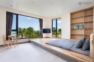 a bedroom with a large bed and a large window at The Rebirth Apartment Binh Chau Ho Tram in Bà Rịa