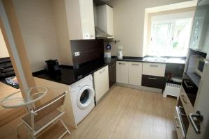 a kitchen with a washing machine and a washer at Charming House - Santarém in Santarém