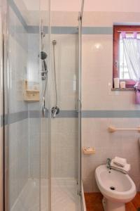 a bathroom with a shower and a toilet and a sink at Glorious Residence Le Pavoncelle one Bedroom sleeps four child num1450 in Santa Teresa Gallura
