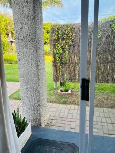 a view of a garden from the door of a house at Settlers Valley Cottage in Port Elizabeth