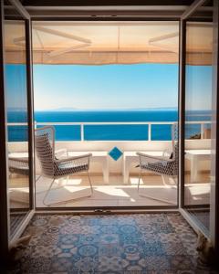 a balcony with chairs and a view of the ocean at Libera Apartments in Stara Baška