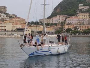 a group of people on a sail boat in the water at Barca a vela BREEZE in Formia