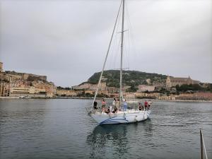 a group of people on a sail boat in the water at Barca a vela BREEZE in Formia