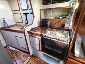 a small kitchen with a stove in an rv at Barca a vela BREEZE in Formia