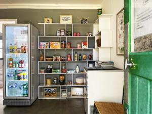 a refrigerator with its door open in a kitchen at Camping Canal de Berry in Saint-Amand-Montrond