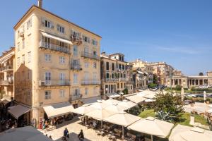 a group of buildings in a street with umbrellas at Liston Bliss Suite in Corfu Town