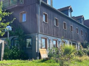 a building with a sign in front of it at Pension Grandel in Kottmar