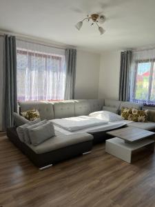 a living room with a large bed and a couch at Apartmán Levoča in Levoča