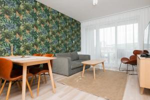 a living room with a table and a couch at Dagály Apartments by UrbanRent in Budapest