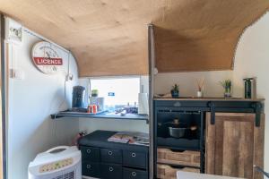 an interior view of a kitchen in a tiny caravan at Cocoon insolite in Pernes-les-Fontaines