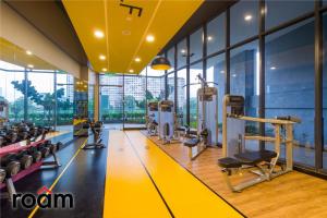 a gym with treadmills and machines in a building at Neu Suites Residence Kuala Lumpur, Roam in Kuala Lumpur