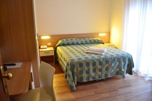 Postel nebo postele na pokoji v ubytování Hotel Midi