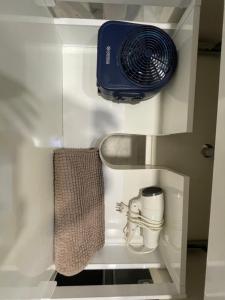 a room with a heater and a fan on a shelf at La Casa de María Castaña in Seville