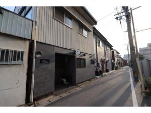 a building with a garage on the side of a street at HAKATA TERRACE -Toki- - Vacation STAY 14934 in Fukuoka