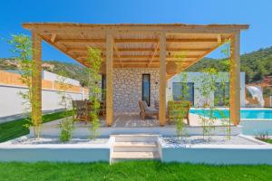 a patio with a pergola and a swimming pool at Casa Di Sabbia 1 in Fethiye