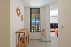 a living room with a table and a window at Casa Di Sabbia 1 in Fethiye