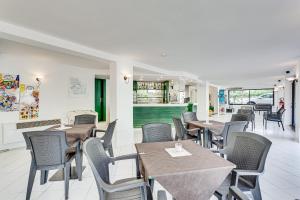 a dining room with tables and chairs in a restaurant at Hotel Costaverde in Cesenatico