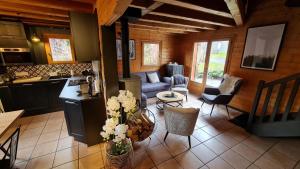 a kitchen and living room in a log cabin at Chalet Van Gogh in Morillon