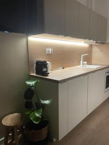 a kitchen with a sink and a toaster on a counter at LeHome Airport Wroclaw in Wrocław