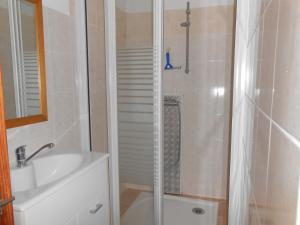 a bathroom with a shower and a sink and a tub at location MIRANDE 2 chambres 4 couchages in Laruns