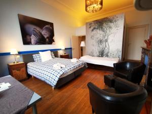 um quarto de hotel com duas camas e uma cadeira em Maison Jamaer em Bruxelas