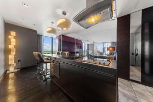 a kitchen with a large island with a counter top at Modern Luxury 17 Floor Panoramic Huge Corner Suite in Las Vegas