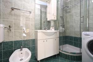a bathroom with a sink and a toilet and a shower at Apartments Slavko 1179 in Banjole +35 photos
