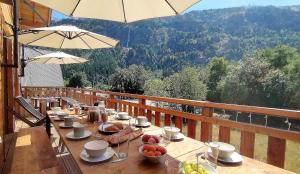 a table with food on it on a balcony at Chalet Le Refuge in Vaujany