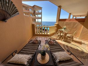 a balcony with a table and chairs and a view of the ocean at El Nautico Apartment in San Miguel de Abona
