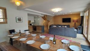 a living room with a table and a couch at Chalet Le Refuge in Vaujany