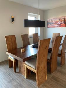 a dining room with a wooden table and chairs at Luxury/Urban Penthouse in Dresden