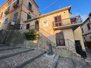 a building with stairs and balconies on a street at B&B Centro Storico in Diamante