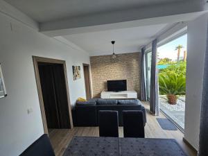 Una sala de estar con un sofá y un televisor. en FeWo Mira, en Vodice