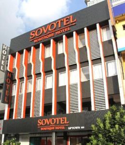 a building with a sign on the side of it at Sovotel Uptown 101 in Petaling Jaya