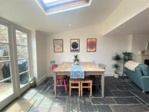 a dining room with a table and chairs at Bohemian Family Home with Gorgeous Garden in Bristol