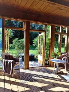 a screened in porch of a house with sliding glass doors at Butterfly Factory in Jonkowo