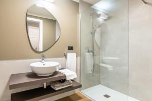 a bathroom with a sink and a mirror at The Place - Only Self Check-in - No Reception in Trento +27 photos