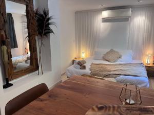 a bedroom with a large bed and a mirror at Boutique Casa Lapicida in Calpe