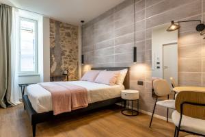 a bedroom with a bed and a table and chairs at The Place - Only Self Check-in - No Reception in Trento
