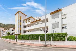 a white apartment building on a city street at PUEBLO in Benalmádena