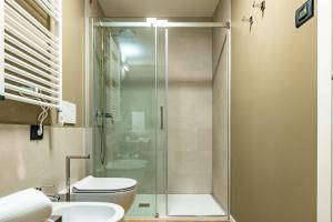 a bathroom with a shower and a toilet and a sink at The Place - Only Self Check-in - No Reception in Trento