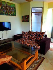 a living room with a couch and a coffee table at New Kitisuru D in Nairobi