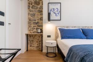a bedroom with a bed and a stone wall at The Place - Only Self Check-in - No Reception in Trento