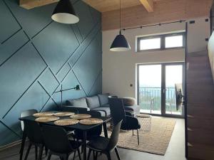 a living room with a table and chairs and a couch at Resort Javorníky in Makov
