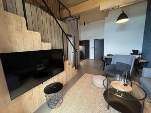a living room with a large flat screen tv at Resort Javorníky in Makov