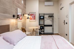 a bedroom with a bed and a table and chairs at The Place - Only Self Check-in - No Reception in Trento