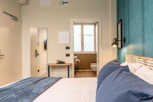 a bedroom with a bed with a blue wall at The Place - Only Self Check-in - No Reception in Trento