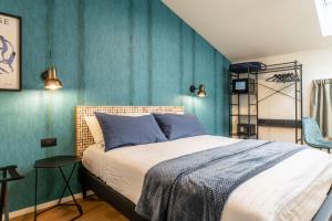 a bedroom with a bed and a blue wall at The Place - Only Self Check-in - No Reception in Trento
